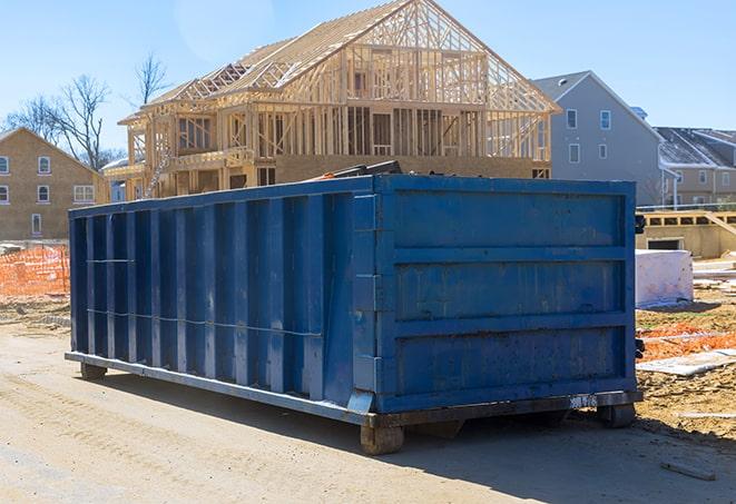 a row of roll-off dumpsters stationed in a residential neighborhood